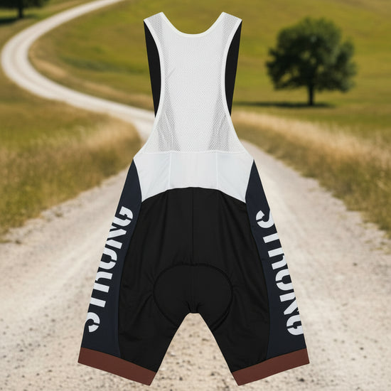 Cycling outfit with a white top and black shorts on a gray background