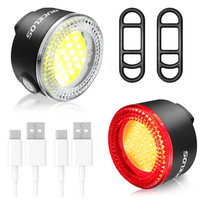 Two bicycle lights with USB cables on a white background