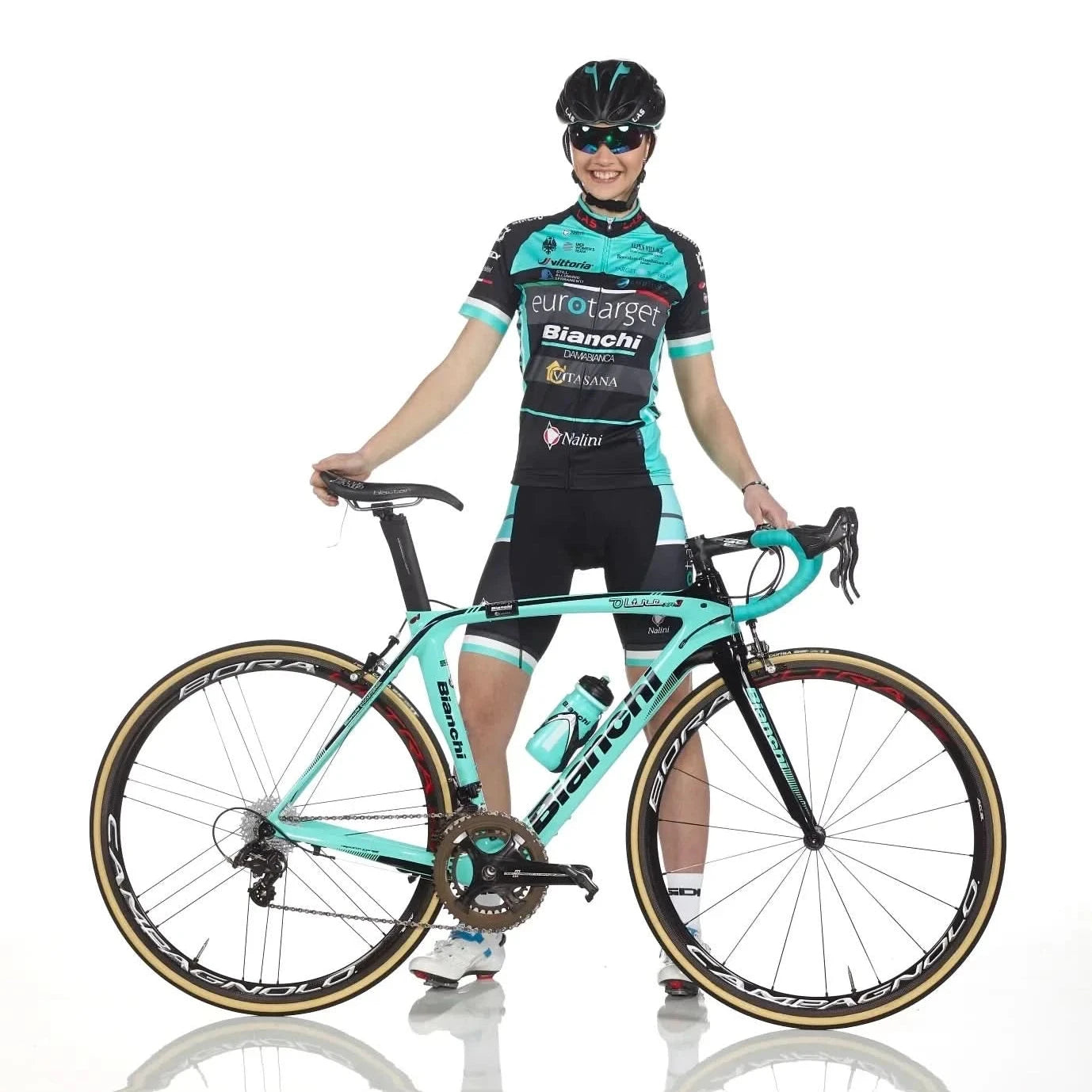 Cyclist in a racing outfit with a turquoise bicycle on a white background