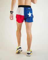 Person wearing a flag-themed athletic shorts with a white star on a plain background